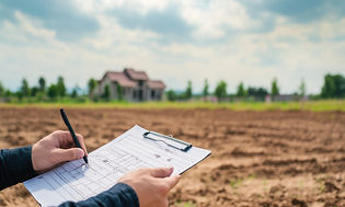Person Holding Blueprint on Construction Site
