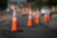 Traffic cones on road with electronic arrow pointing to the right to divert traffic and wh