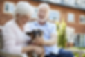 Happy Couple In Senior Living Community with Dog