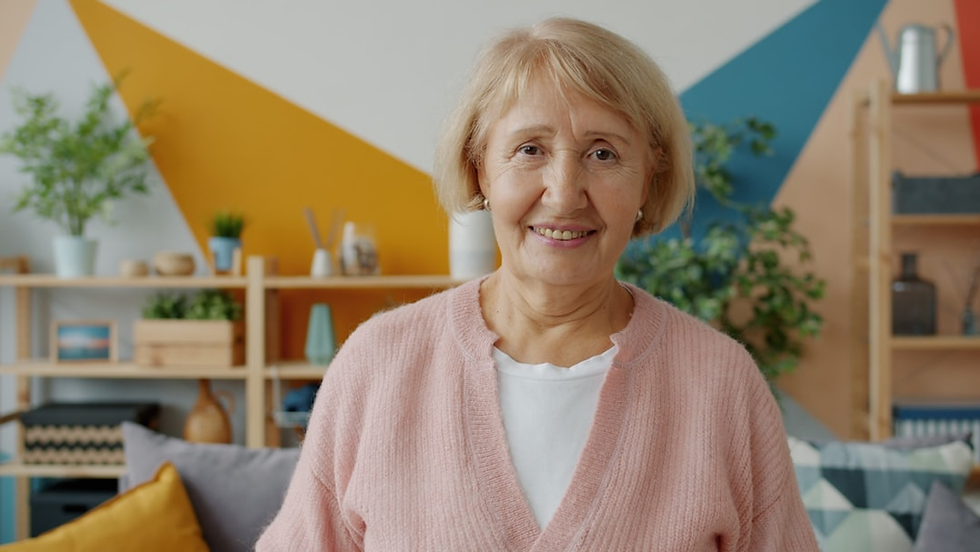 An elderly lady at home in her living room.