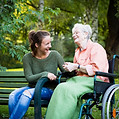 charming young woman and senior woman taking timeout in the park