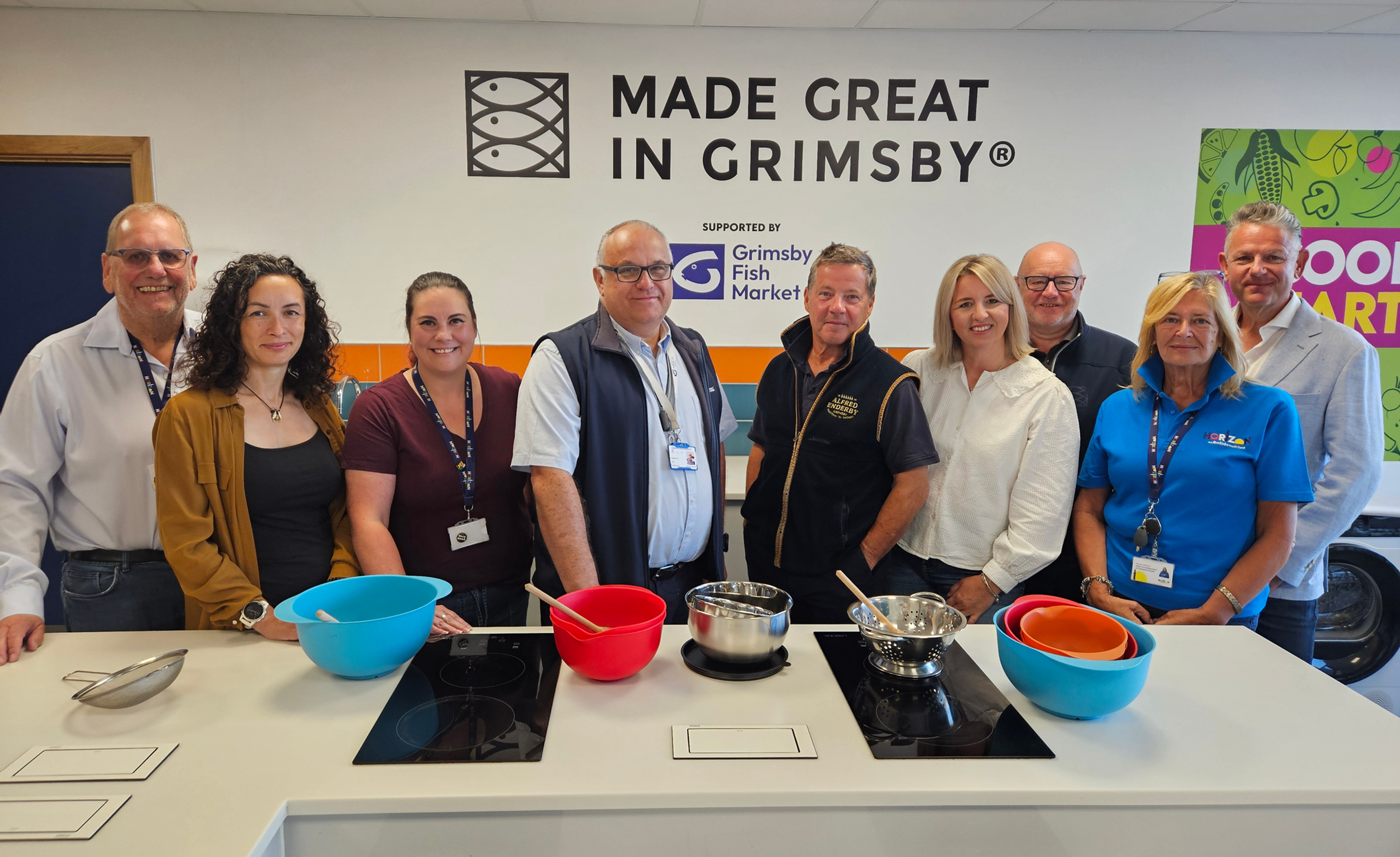 Chair of trustees, Mike Parker, left, chief executive Lucy Ottewell-Key, third left, and head of fundraising and communications, Fiona Wright, second right, welcome (from second left) Rachel Hopton, HR manager at New England Seafood International; Andrew Oliver, chief executive at Grimsby Fish Dock Group; Patrick Salmon, Joanne Woodhouse and Simon Dwyer, all representing Made Great in Grimsby, and Darren Beecham, group operating director at New England Seafood International.