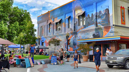 The main square just west of the Union building in the downtown Pomona Arts Colony, complete with exquisite Our Lady of Pomona large wall mural in blues overlooking a tranquil pedestrian scene on a typical Art Walk Saturday.