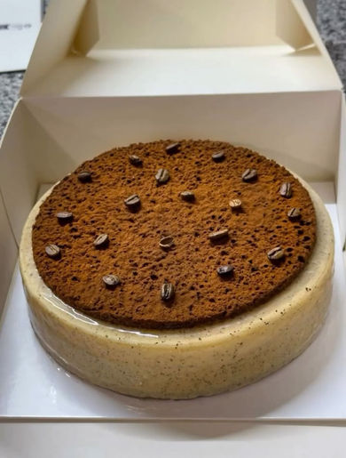 Round cake with cookie crust and chocolate chips in a box