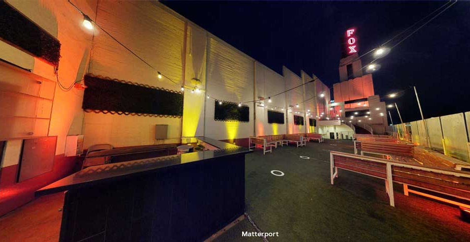 a long view of the Garey Rooftop section at night with no people and the Tower in the distance at the Fox Theater in Pomona