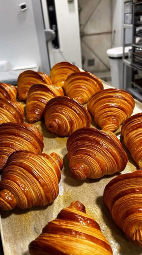 Tray of freshly baked golden croissants