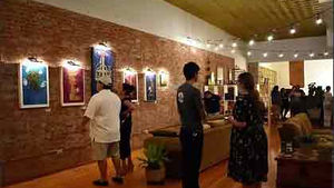 Art exhibition at Pomona Arts Colony: artwork on display, visitors admiring pieces