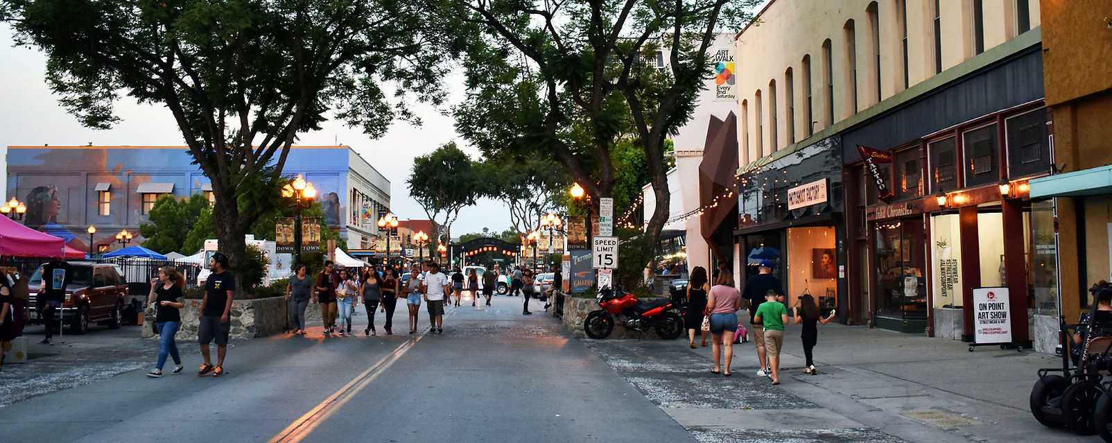 Pomona Downtown Artwalk Street scene with people walking along a closed off 2nd Street on 2nd Saturday