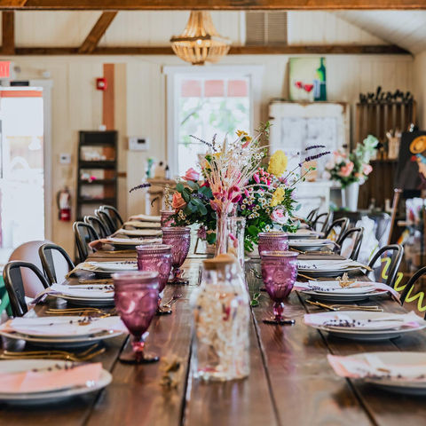 Rustic table setting with floral centerpiece, no people yet