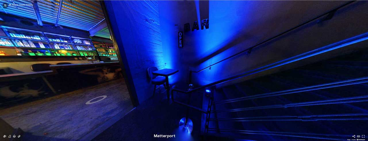 the entrance door from inner stairwell to the Flyway Lounge with small bouncer table and blue lighting at the Fox Theater in Pomona