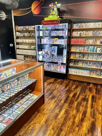 Retro video game store interior, shelves and display cases packed with games.