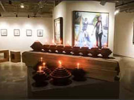 Art gallery exhibit: paintings and candles