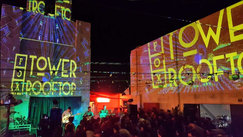 live action night photo of a Tower Rooftop event with projected lights and crowd at the Fox Theater in Pomona