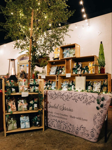 Sundial Botanicals market stall with products on wooden shelves