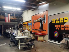 Sewing studio interior with "Hard Work" sign