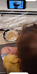 A young child watching Ms Raven on a phone