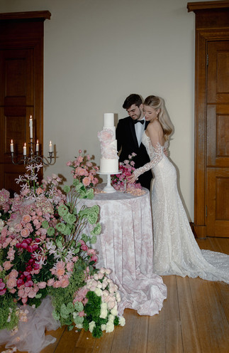 Luxury wedding table cake design with sculptural flowers in soft blush and green tones