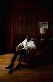 minimal and moody groom prep with white suit at kinmount house