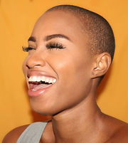 Beautiful woman with shaved head and gorgeous smile.