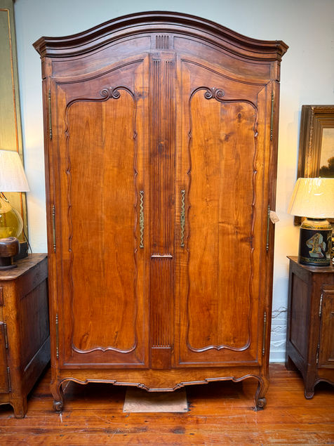 Antique French cherry armoire with chapeau de gendarme top and brass hardware