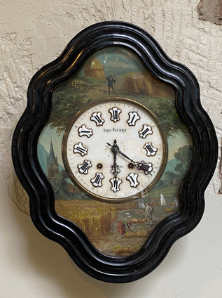 Antique French Napoleon III ebony diamond-shaped wall clock with pastoral scene around enamel clock face stamped Eugene Sicard
