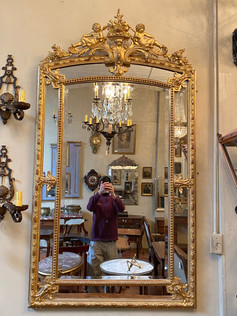 Antique French gilt Louis XVI style pareclose mirror with cherub cartouche and beveled glass