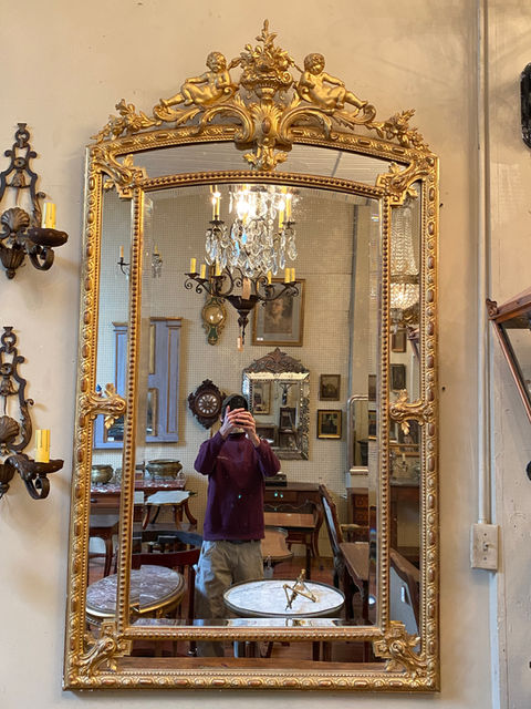 Antique French gilt Louis XVI style mid - late 19th century pareclose mirror with cherub cartouche and beveled glass