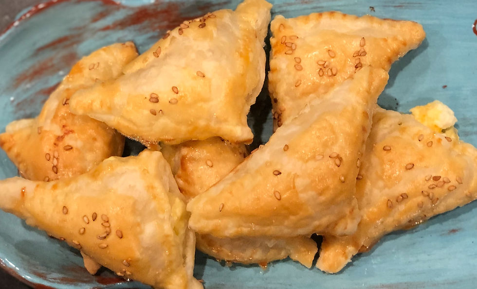 A plate of Potato Puff Pastries topped with sesame seeds.