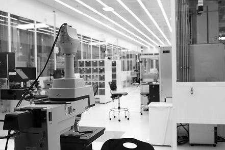 Cleanroom laboratory with precision optical inspection equipment used in advanced hardware manufacturing.