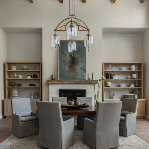 Modern rustic living room with aged wood beams, a warm neutral palette, and layered natural textures