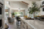 Open-concept kitchen and living area with vaulted ceiling, natural light, and organic textures in a custom Sonoma County home by Robin Heard Design.