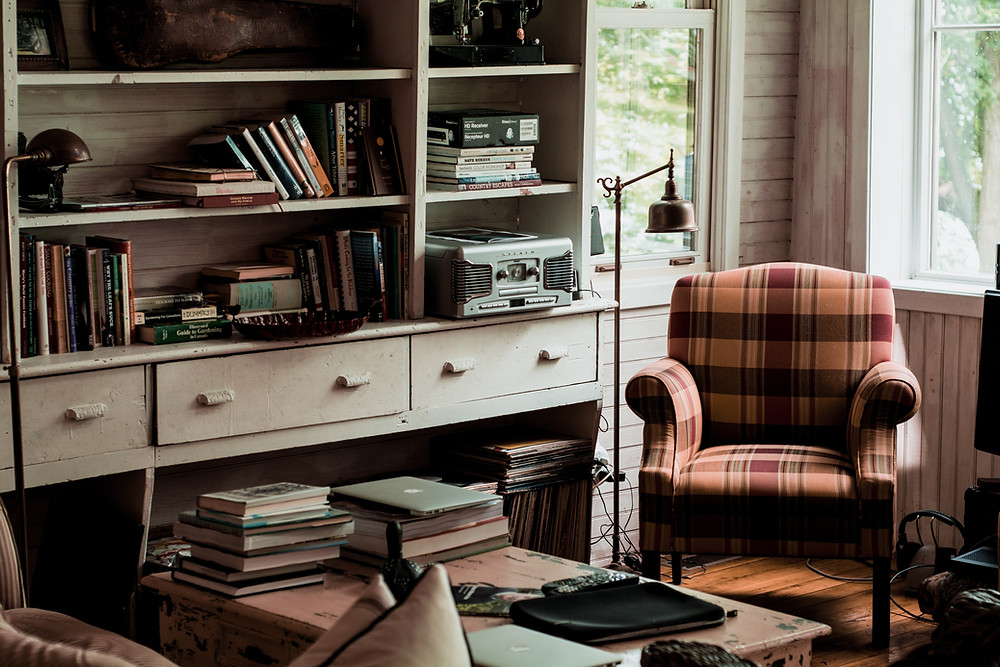 Ellipsis Editing professional editing services for academics. Image includes chair, bookcase and books.
