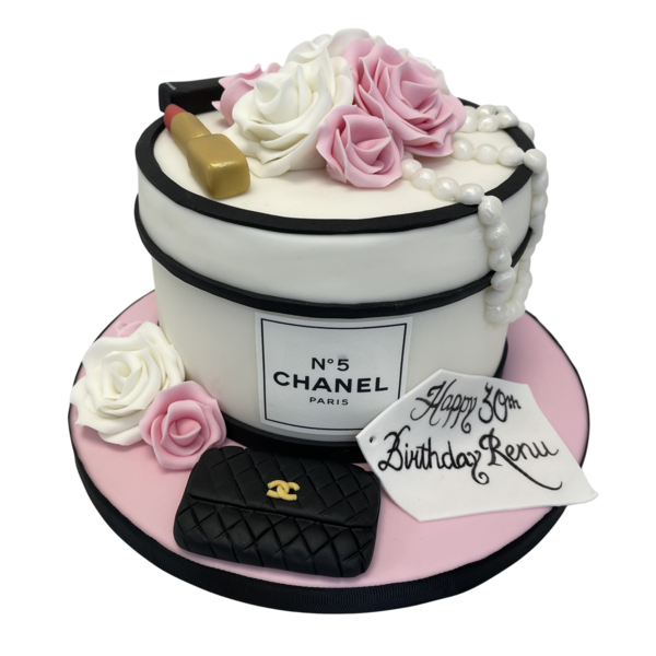 Luxurious Chanel-themed cake with intricate designs and delicate roses, perfect for fashion lovers and special occasions.