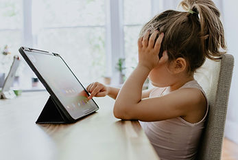 young girl stressed tapping on tablet