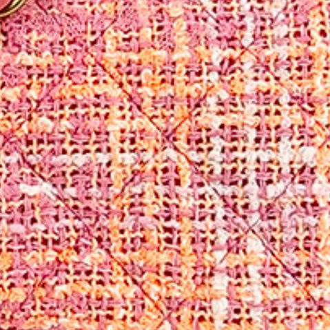 Close-up of a Chanel Classic Flap bag showing the tweed material