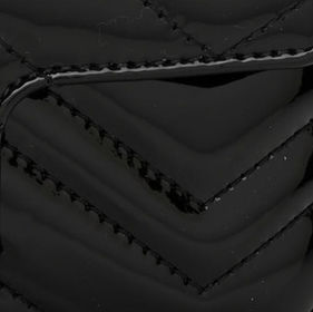 Close-up of a Gucci GG Marmont bag showing the patent leather material