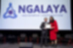 Dani Larkin accepts her award on stage from Ngalaya CEO Jason O'Neil at the 2022 Ngalaya Ball