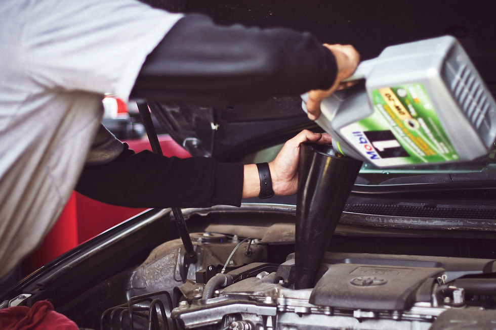 Man pouring oil into car's engine