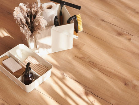 a wood floor with summer cleaning supplies on it
