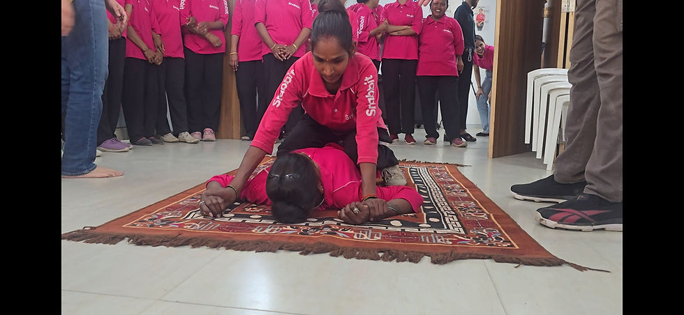 Ground defense and floor-pin escape drills at a Kombat Hall corporate self defense workshop.