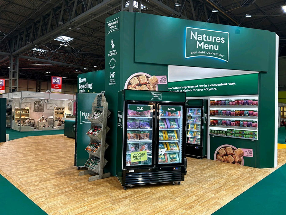 Custom exhibition stand for Natures Menu at Crufts. On the exhibition stand sits large lightboxes and graphic displays, product displays, digital screens and a range of branded graphic treatments.