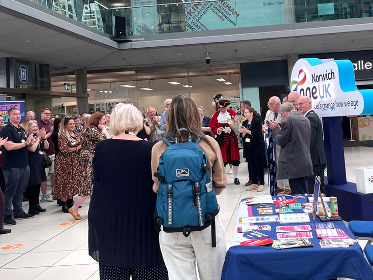 The crowd clap as the ribbon is cut in front of the Age UK Norwich exhibition, by the Mayor and Sheriff of Norwich.