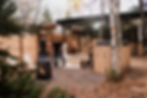 Couple strolling on a leaf-lined path by a fire pit at RnR Glamping Resort, reflecting the tranquil