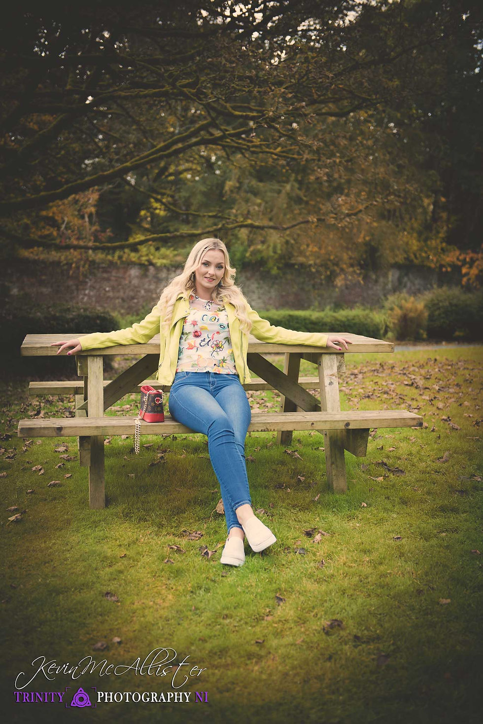 blonde model seated at park bench