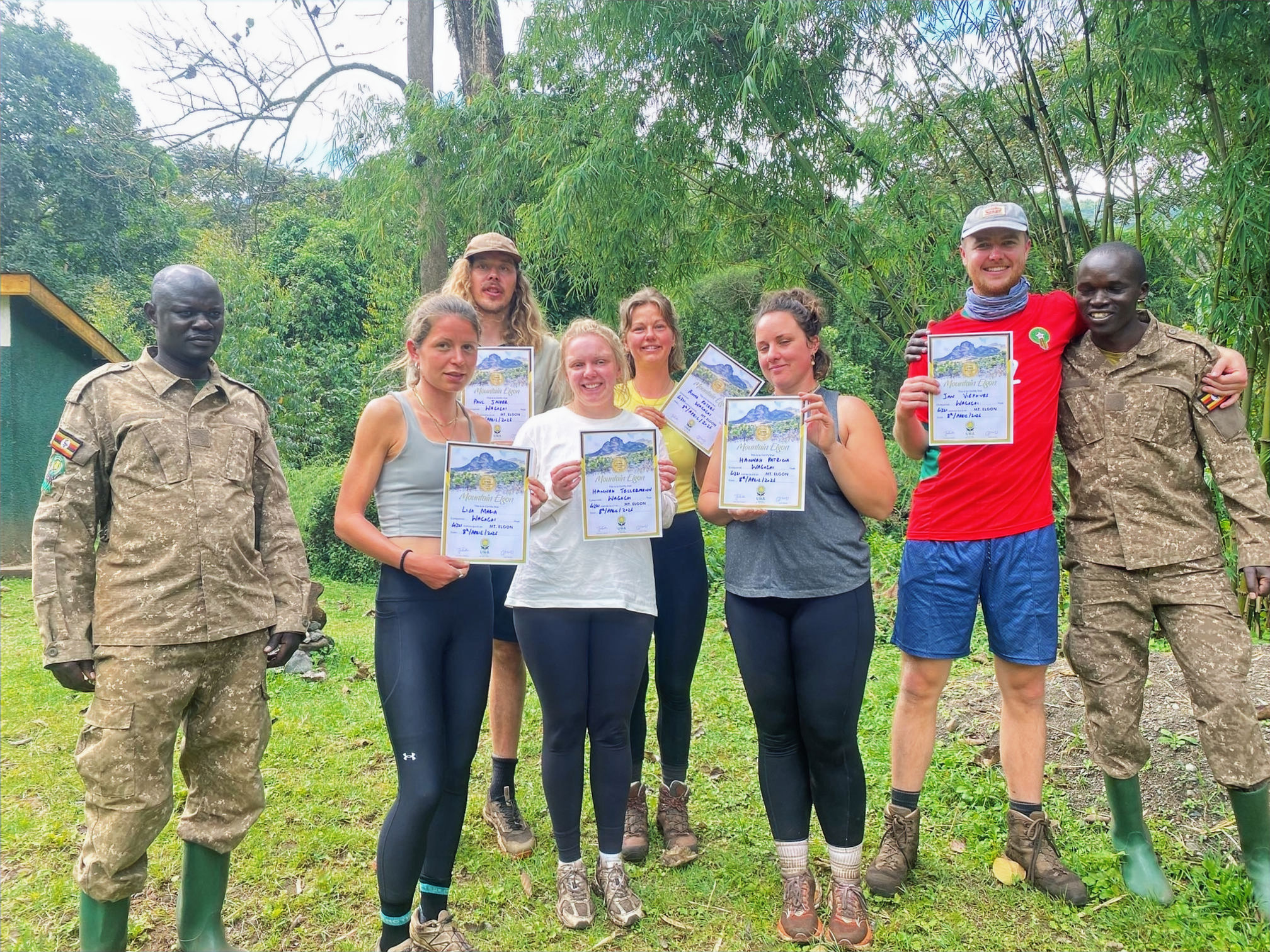 Group of tourists on a forest hike with a guide and dense foliage.