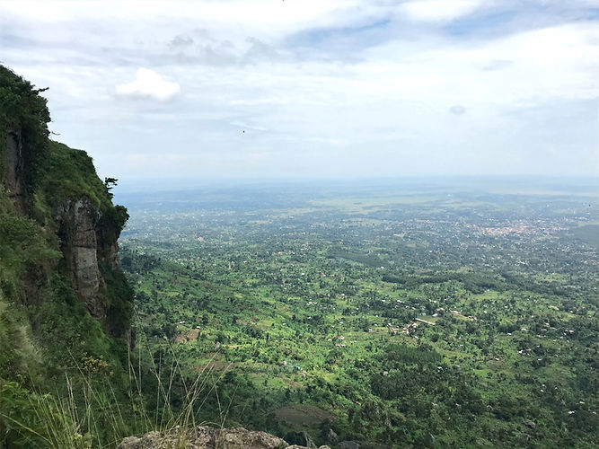 Scenic view of green landscape, mountains, and cloudy sky. At Wanale Ridge Tour.