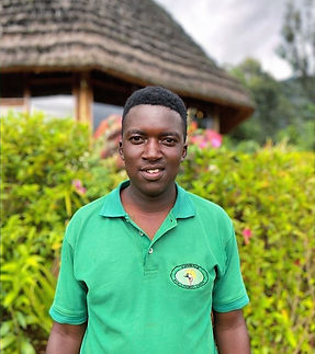Smiling man in green polo shirt one of mount elgon eco tours guides