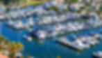 Overhead drone view showcasing yachts and boats docked at a Miami marina.