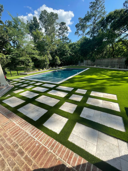 Stepping stones path beside pool and lush TurfTex lawn