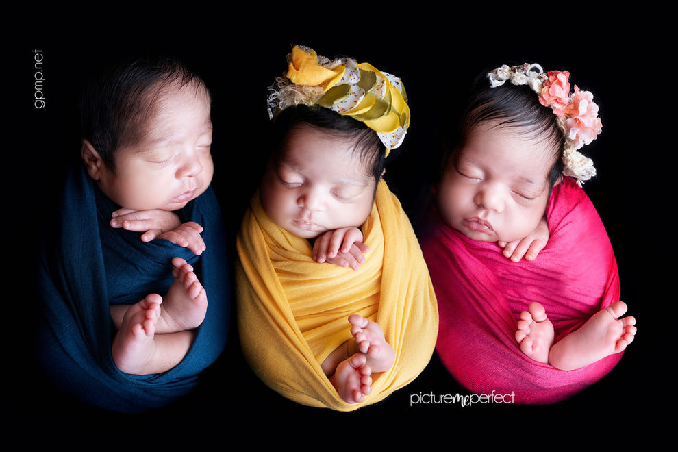 triplet babies sleeping . newborns in blue, yellow, and fucia wraps. Miami Silver Lakes photo shoot
